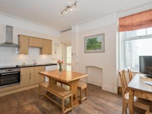 a kitchen and dining room with a wooden table at Hartrees House in Silecroft
