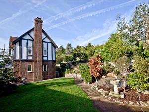 a brick house with a chimney and a yard at Bishopsgate in Torquay