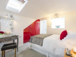 a bedroom with a bed and a red door at Florizel in Falmouth