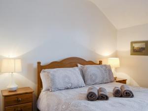 1 dormitorio con 1 cama con 2 zapatillas en Glenwood - 18630, en Keswick
