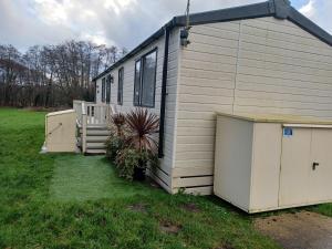 a small house with a porch and a yard at Foxglove 10 in Ringwood