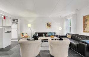 a living room with a couch and a table at Gorgeous Apartment In Bindslev With Wifi in Bindslev