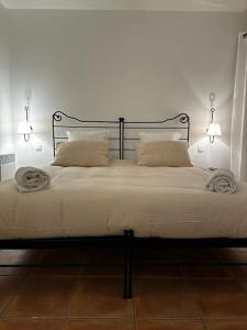 a white bed with two lights on top of it at Escale détente - Résidence 4* au sein d'un Golf in Saumane-de-Vaucluse