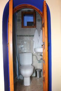 a bathroom with a toilet and a sink at Hotel Gernika in Chefchaouene