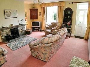 a living room with a couch and a fireplace at Low West in Hexham
