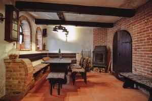 a living room with a table and a brick wall at Skácelův dům in Valtice