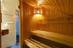 a wooden sauna with a light in a bathroom at Lipno Lake Resort in Lipno nad Vltavou