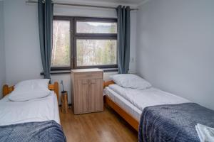 Postel nebo postele na pokoji v ubytování Ski Lodge przy Gondoli