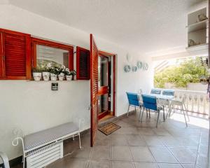 a dining room with a table and chairs in a room at Apartment Nadica Sabunike in Privlaka