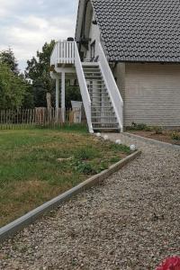 a house with a white staircase leading up to a house at Ostseeblick im Andersenhof in Kappeln