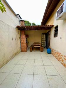 un patio al aire libre con una mesa y un edificio en Condomínio Dell Mar, en Bertioga 3 fotos más