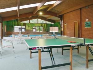 a ping pong table in a room with tables and chairs at Blea Tarn in Elterwater