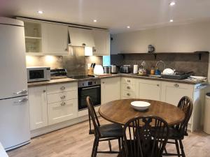 a kitchen with a table and chairs in it at Bridge House in Threlkeld