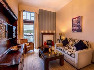 a living room with a couch and a table at Captains Folly in Oban