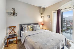 a bedroom with a bed and a large window at Palm Beach At Rockaway Beach in Rockaway Beach