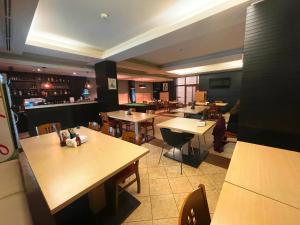 a restaurant with tables and chairs and a bar at Bellevue Residence Apartments in Bansko