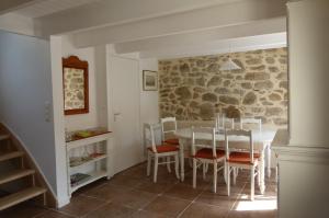a kitchen and dining room with a table and chairs at La maison de Jeanne in Pont-Croix