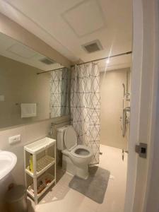 a bathroom with a toilet and a sink at Amenity View Studio Azure North in San Fernando