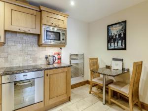 a kitchen with a table and a counter top at Orchard Sands in Beadnell