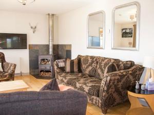 a living room with a couch and a wood stove at The Narrows in Inveralligin