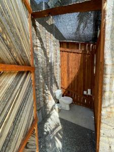 a bathroom with a toilet in a building at Hostel Flakos in Zihuatanejo