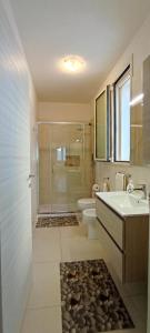 a bathroom with a sink and a toilet and a shower at La Casetta 22 in Andrano