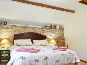 a bedroom with a bed with two towels on it at The Old Smithy in Llanbadarn-fynydd