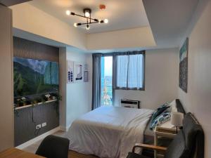 een slaapkamer met een bed en een groot raam bij Amenity View Studio Azure North in San Fernando