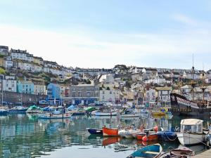 a group of boats docked in a harbor with houses at Apple Barn Cottage in Brixham