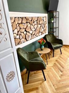 two green chairs in a room with a stone wall at Płazowianka in Witów