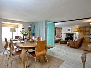 a dining room with a table and chairs and a living room at Lyndale Cottage in Cawsand