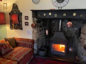 a living room with a fireplace and a couch at Duvale Priory - 9985 in Bampton