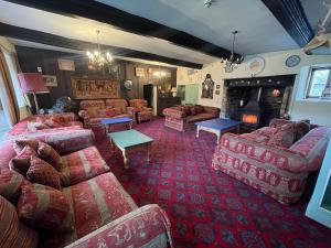 a large living room with couches and a fireplace at Duvale Priory - 9985 in Bampton