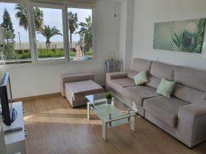 a living room with a couch and a table at Primera línea playa in Roquetas de Mar
