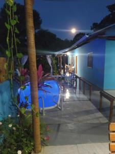 a resort with a pool at night at pousada corais de abrolhos in Caravelas