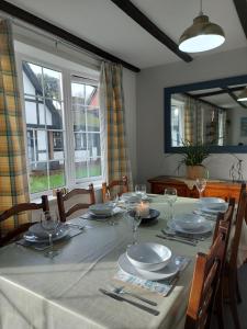 a dining room table with plates and glasses on it at 3.9. Tudor Court in Hayle