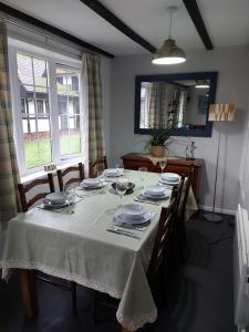 a dining room table with plates and glasses on it at 3.9. Tudor Court in Hayle