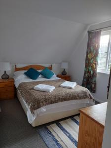 a bedroom with a bed with two pillows on it at 3.9. Tudor Court in Hayle