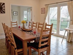 a dining room with a wooden table and chairs at Haugh House in Aberlour
