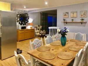 a kitchen and dining room with a wooden table and chairs at Driftwood in Mainsriddle