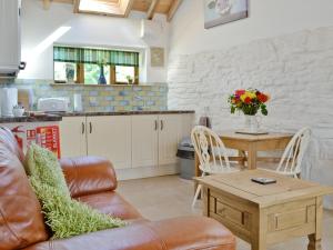 a living room with a couch and a table at The Dairy in Arlingham