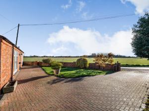 a brick driveway in front of a brick building at Barn Owl Cottage in Wisbech