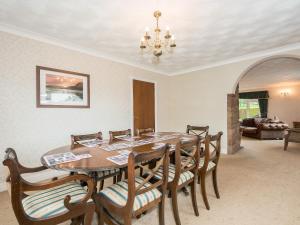 a dining room with a table and chairs at Oaklands in Langrigg