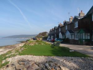 a row of houses on a street next to the water at Shore Cottage in Silverdale