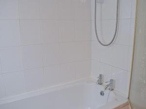 a bathroom with a shower with a bath tub at Three Ash Cottage in Bungay