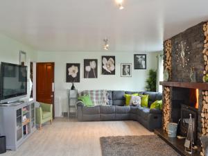 a living room with a couch and a television at Hillcrest House in Endon