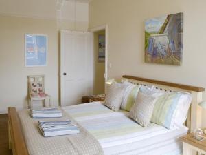 a bedroom with a bed with towels on it at Grosvenor Cottage in Alnmouth