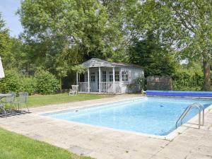 a swimming pool in a yard with a gazebo at Cravens Manor in Sotherton
