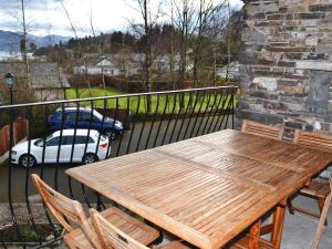 a wooden table and chairs on a balcony at Derwentwater View in Portinscale