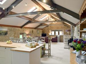 a kitchen and dining room with exposed beams at Sikes Laithe in Kilnsey